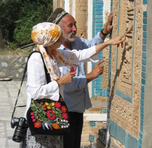 two people examining wall