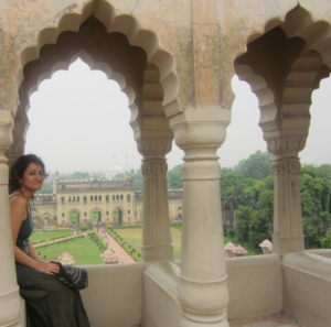 woman leaning under architectural arch